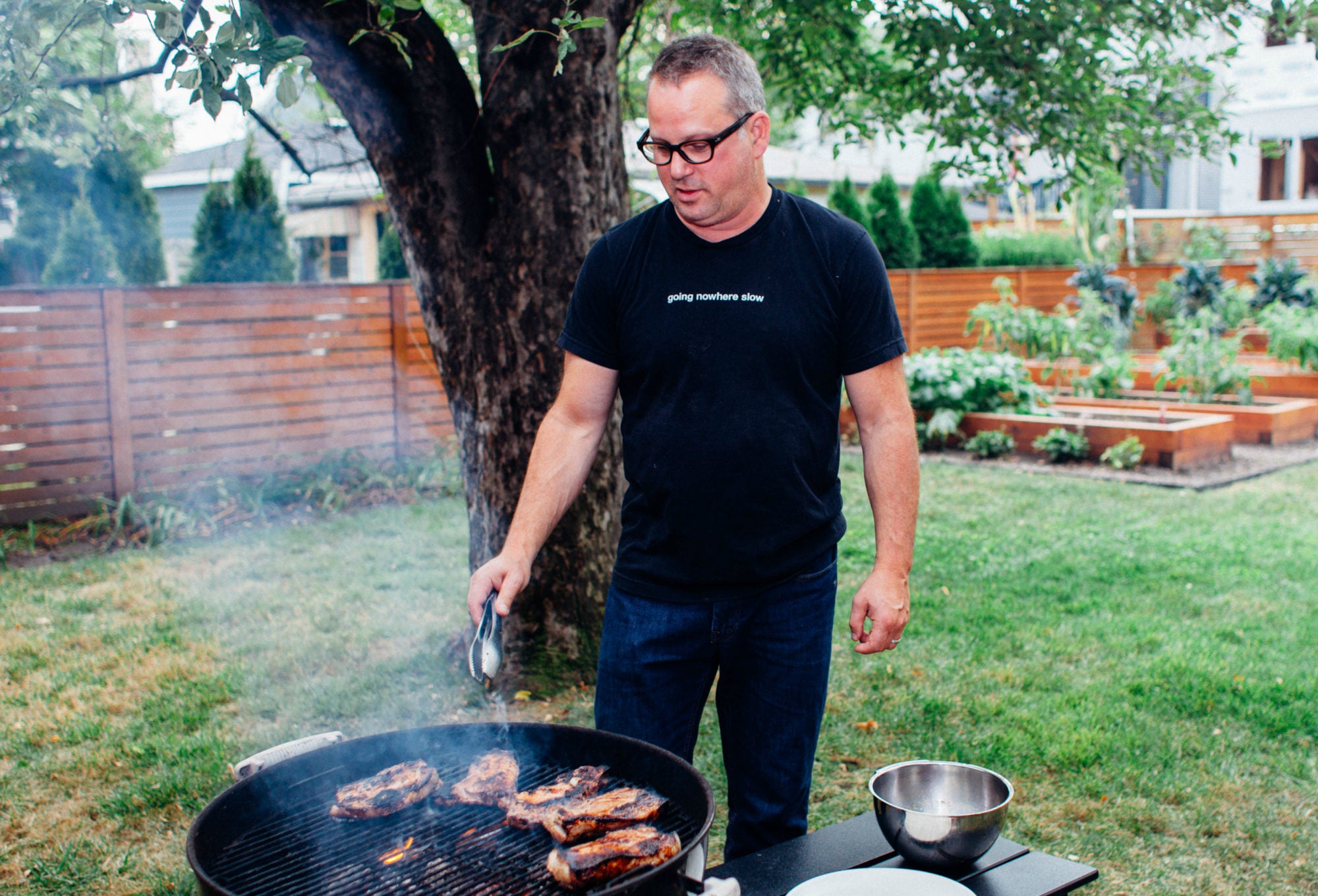 Paul Kahan grills ribs in his backyard in Chicago, IL, October 2, 2017.